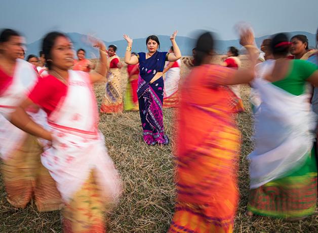 Purnima Devi Barman seen in the middle of a group of women dancing, the "Hargila Army"