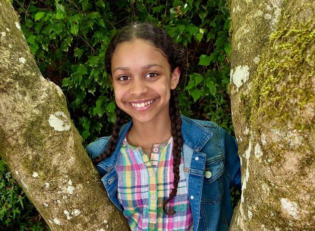 A photo of Piper Bayard smiling in nature.