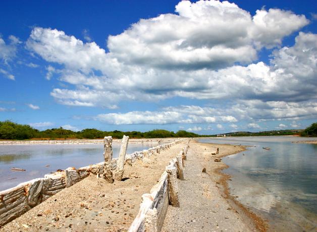 View of Cabo Rojo salt flats beneath a partly cloudy sky