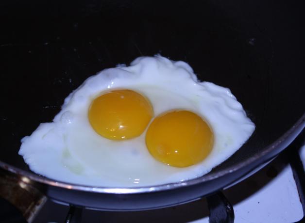 A double-yolked egg in frying pan