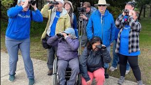 Birdability members pose together outdoors as "Team Nuthatch," having competed in the 2022 World Series of Birding