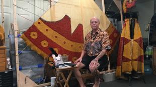 Rick San Nicolas in his studio crafting a traditional feather skirt